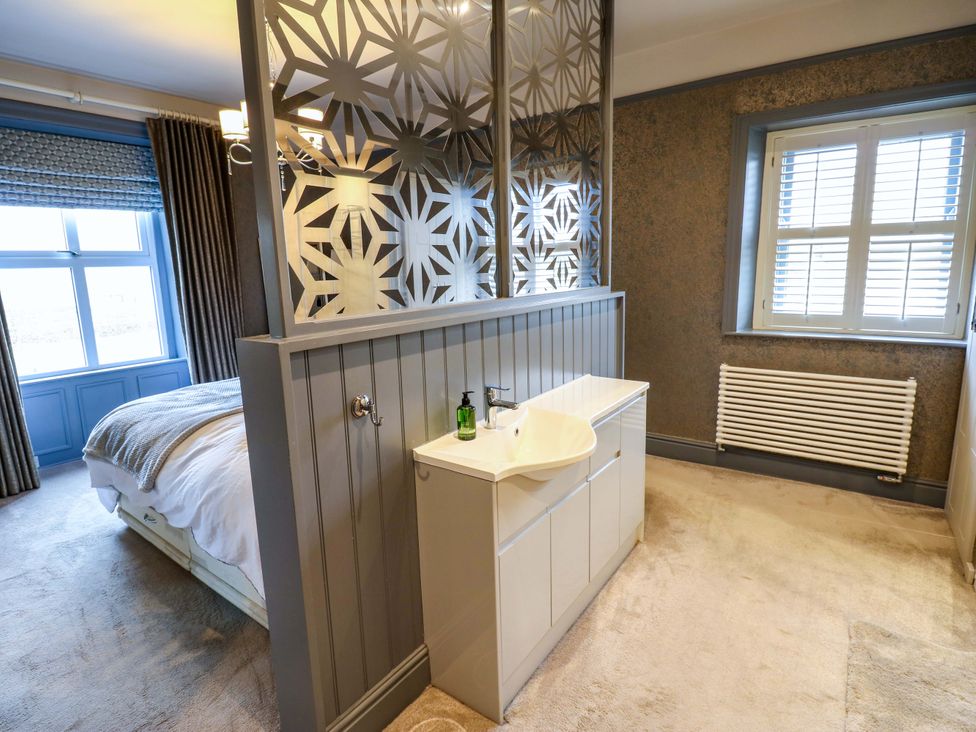 A bedroom with a sink and a bed at Langcliffe House Kettlewell