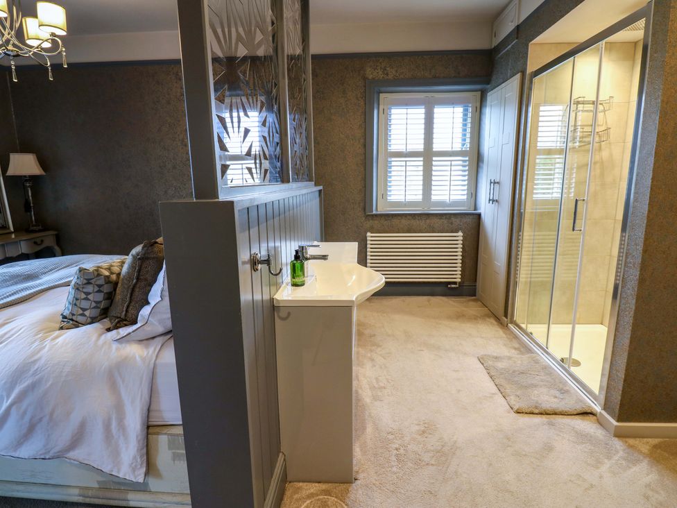 A bedroom with a bed and shower at Langcliffe House Kettlewell