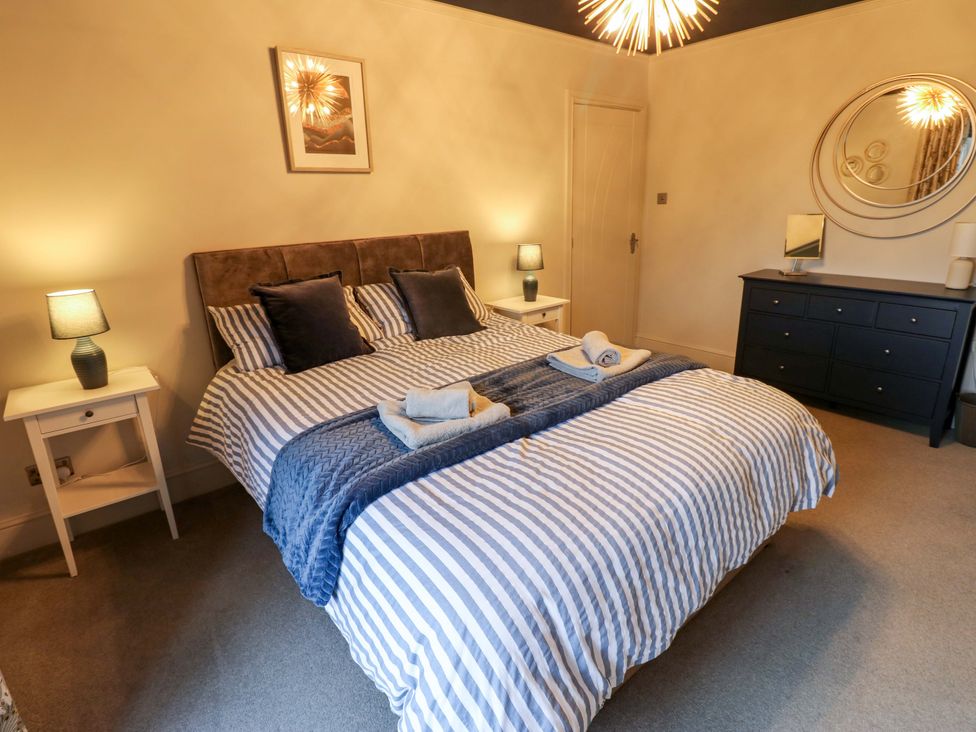 A bedroom with a bed and bedside tables at Langcliffe House in Kettlewell