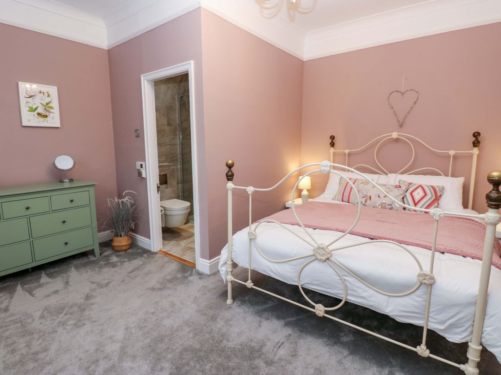 A bedroom with a bed and dresser at Langcliffe House in Kettlewell