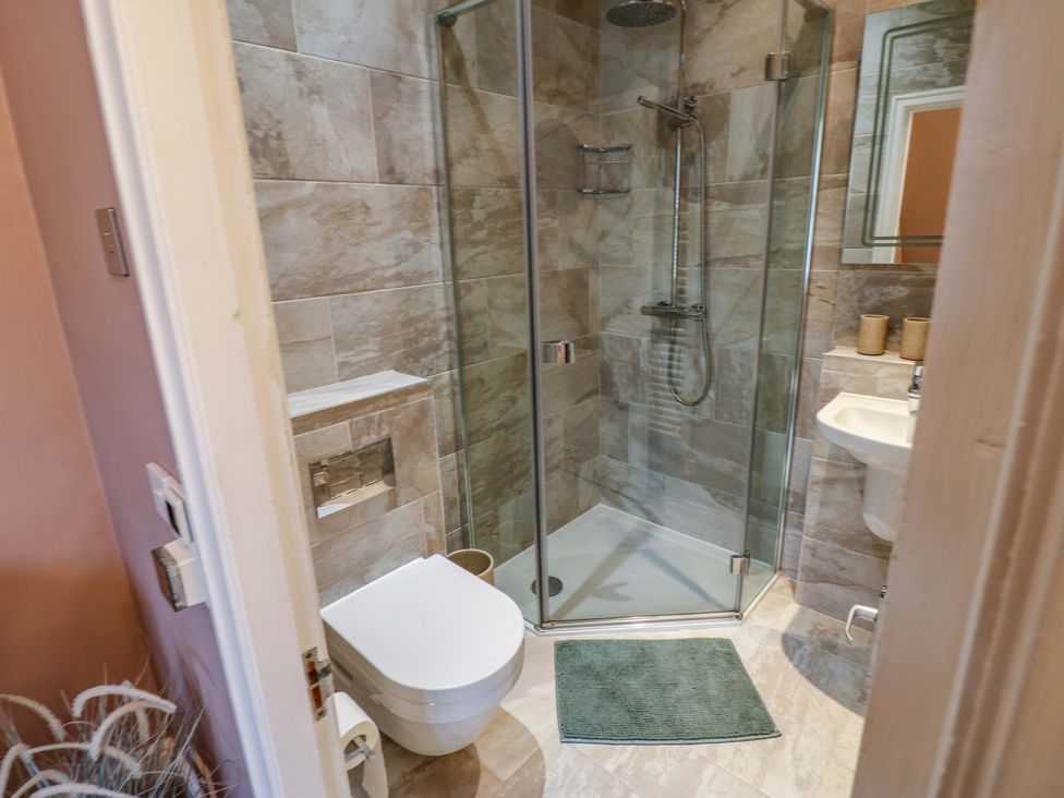 A bathroom with a shower and sink at Langcliffe House in Kettlewell