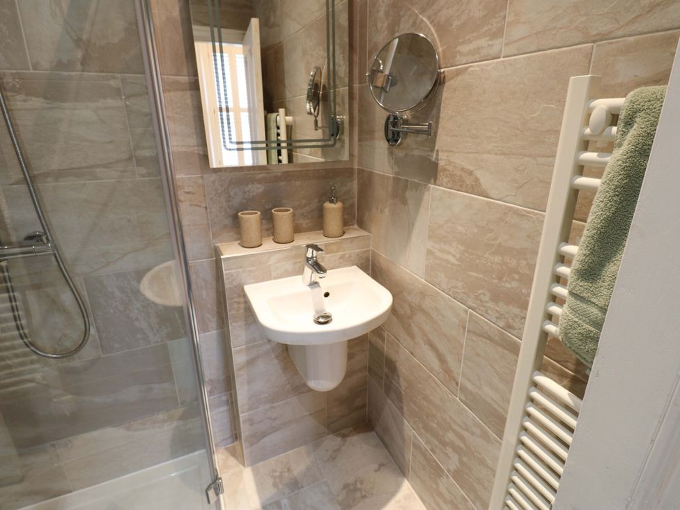 A bathroom with a shower and sink at Langcliffe House in Kettlewell