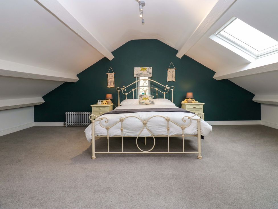 A bedroom with a double bed and nightstands at Langcliffe House in Kettlewell