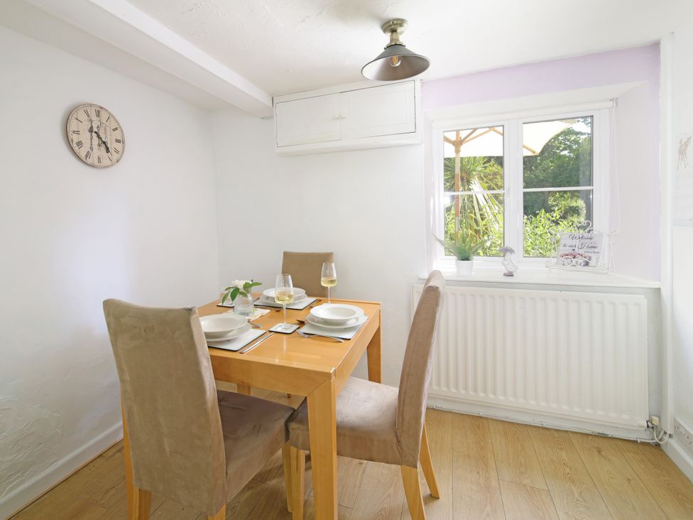 A dining room with a table and chairs at Lavender Cottage in Bourton, Dorset
