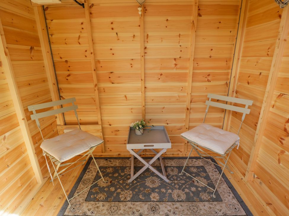A snug with chairs and a table at Lavender Cottage in Bourton, Dorset