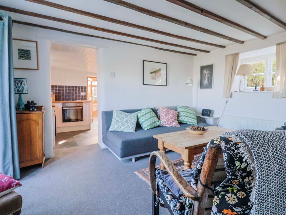 A living room with a sofa and coffee table at 2 Oak Tree Cottages, Marshwood Nr. Hawkchurch