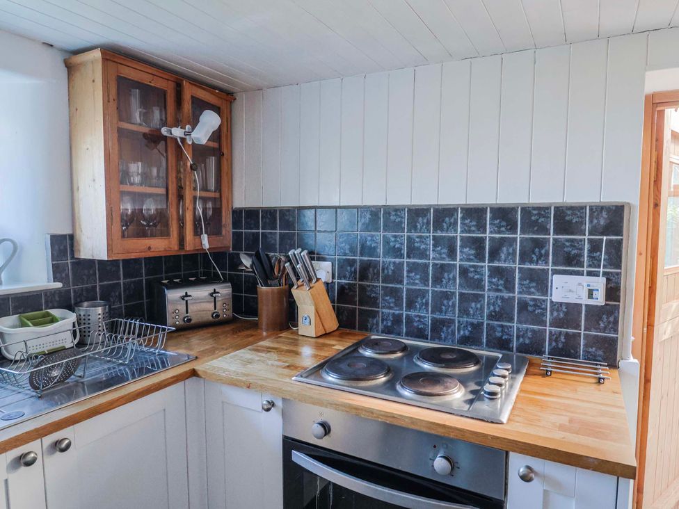 A kitchen with stove, oven, sink, and kitchen cabinet at 2 Oak Tree Cottages Marshwood Nr. Hawkchurch