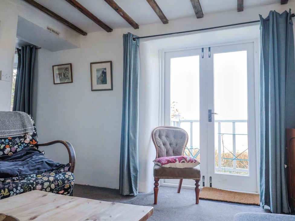 A living room with a sofa and chair at 2 Oak Tree Cottages in Marshwood Nr. Hawkchurch