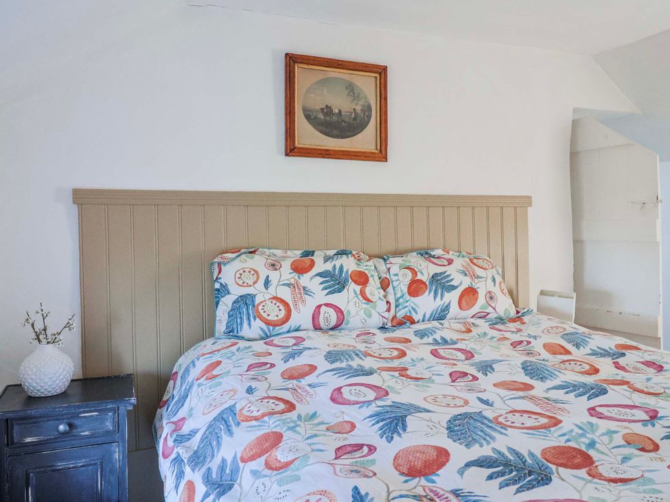 A bedroom with a bed and a bedside table at 2 Oak Tree Cottages, Marshwood Nr. Hawkchurch