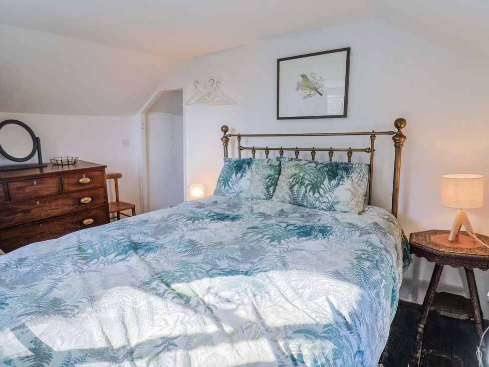 A bedroom with a bed and dresser at 2 Oak Tree Cottages Marshwood Nr. Hawkchurch