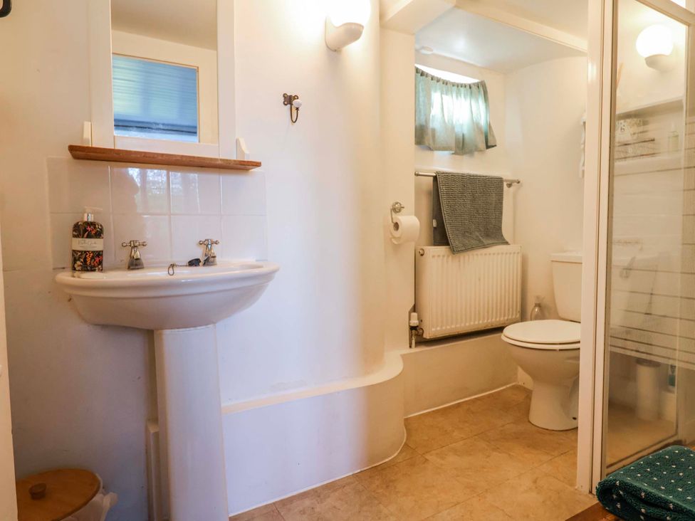 A bathroom with a sink, toilet, and shower at 2 Oak Tree Cottages Marshwood Nr. Hawkchurch