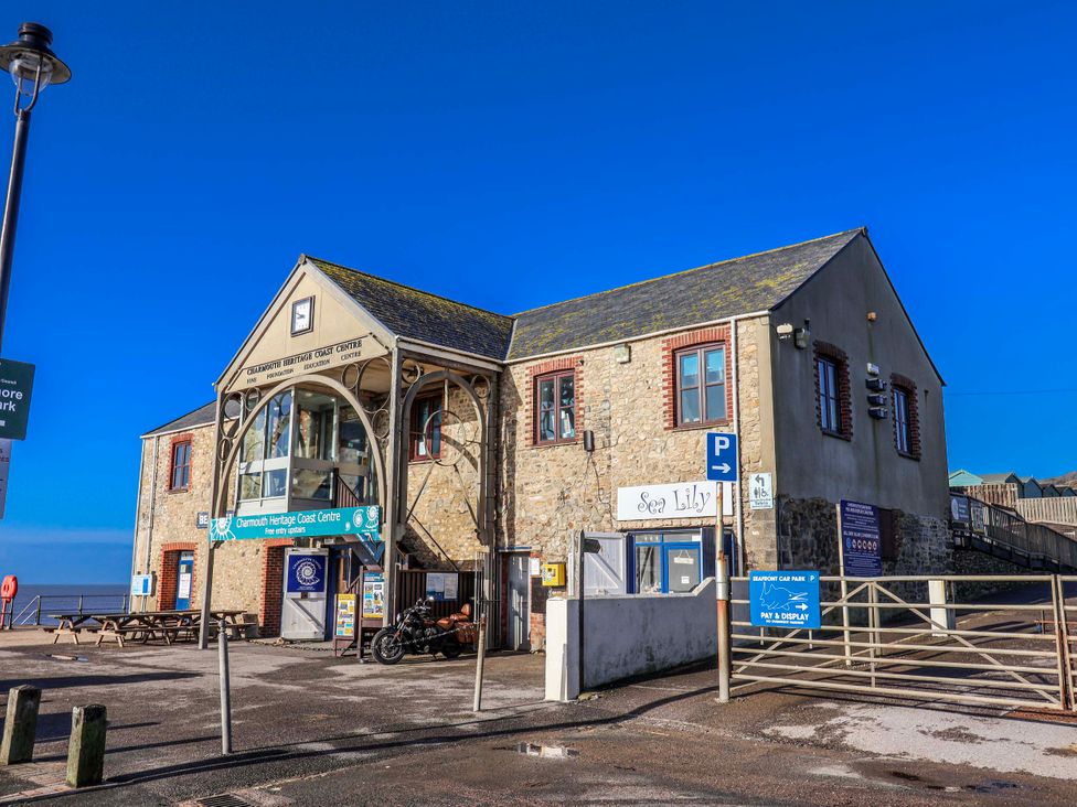 A building with a sign and parking area at 2 Oak Tree Cottages in Marshwood Nr. Hawkchurch