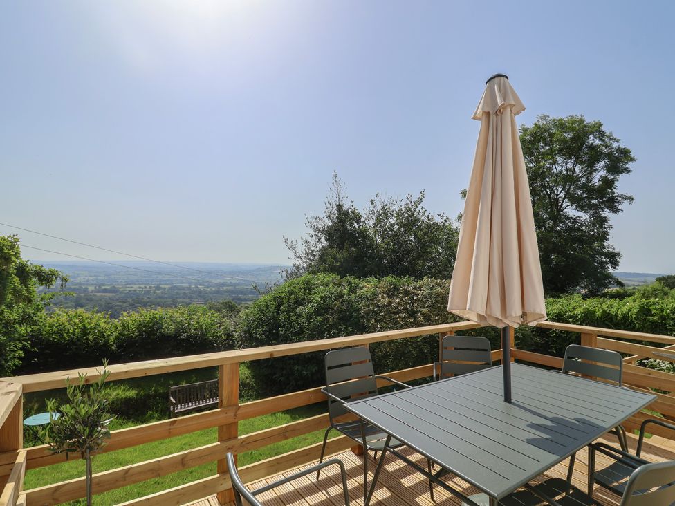 An outdoor seating area with a table and chairs at 2 Oak Tree Cottages Marshwood Nr. Hawkchurch
