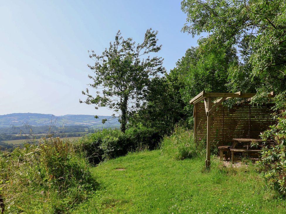 A garden area with seating overlooking a landscape at 2 Oak Tree Cottages Marshwood Nr. Hawkchurch