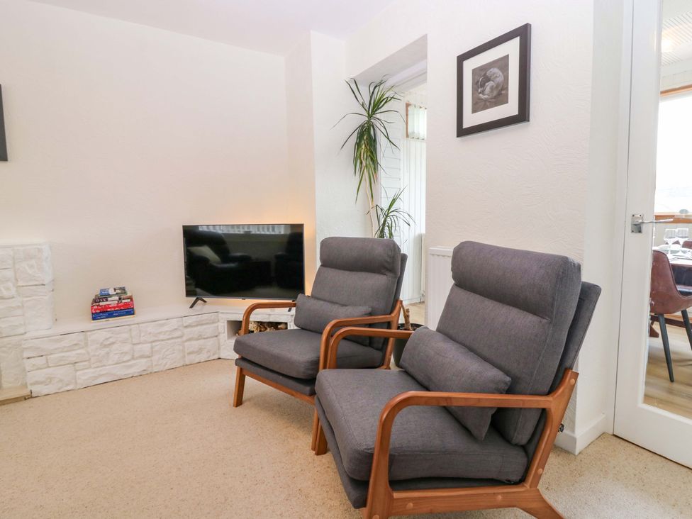 A living room with armchairs and a television at Parkhill in Dairsie