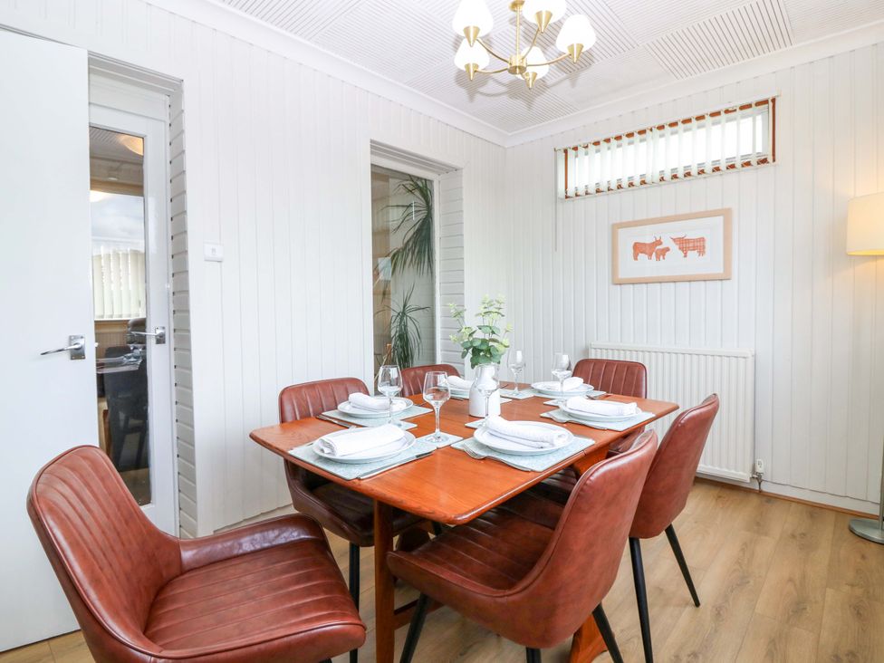 A dining room with a table set for dinner at Parkhill in Dairsie