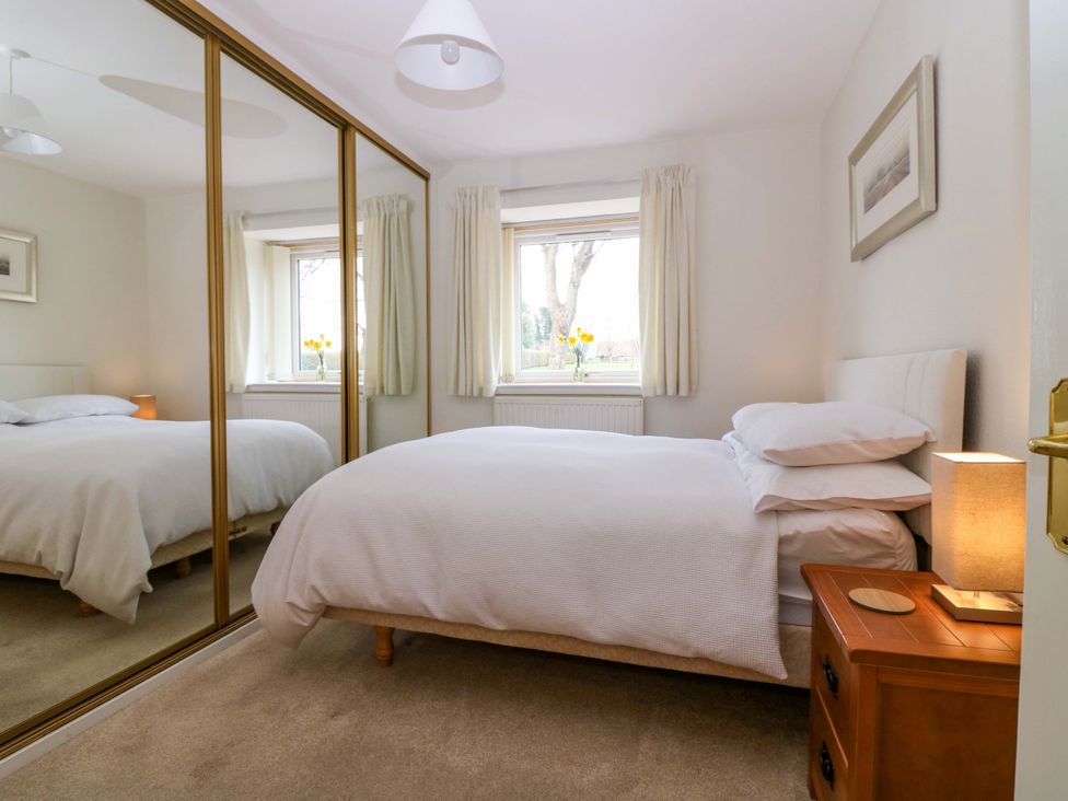 A bedroom with a bed and nightstand at Parkhill in Dairsie