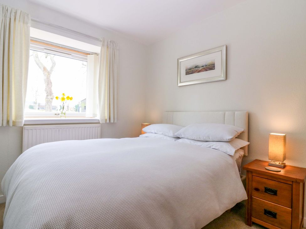 A bedroom with a bed and window at Parkhill in Dairsie