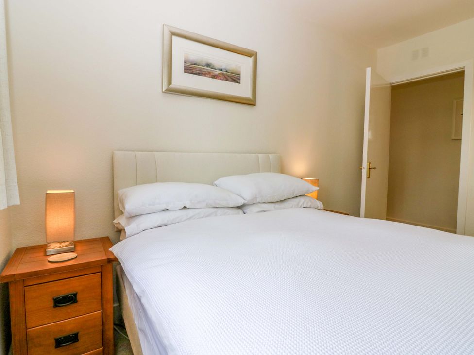 A bedroom with a bed and bedside table at Parkhill in Dairsie