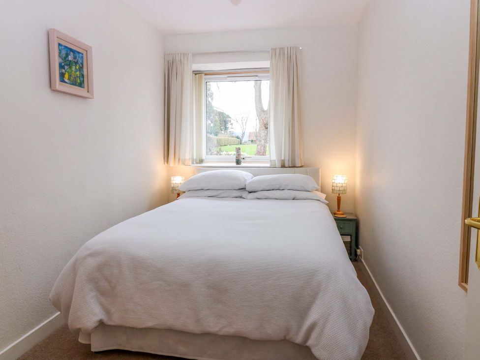A bedroom with a bed and lamps at Parkhill in Dairsie