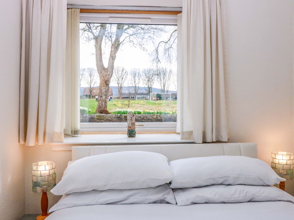 A bedroom with a window and a bed at Parkhill in Dairsie