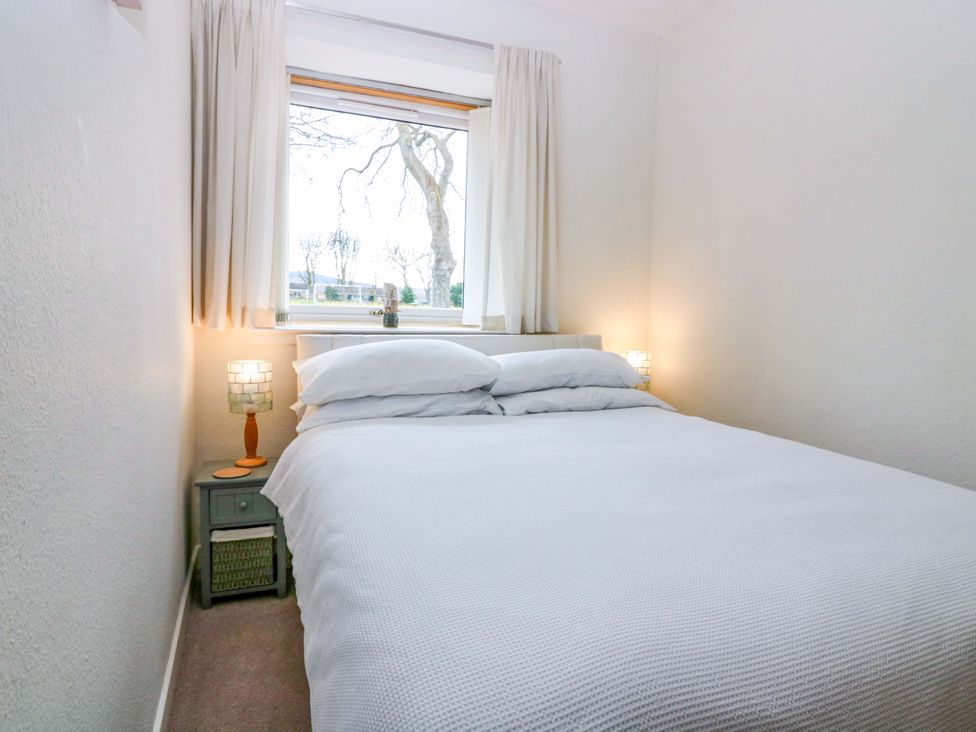 A bedroom with a bed and bedside table at Parkhill in Dairsie