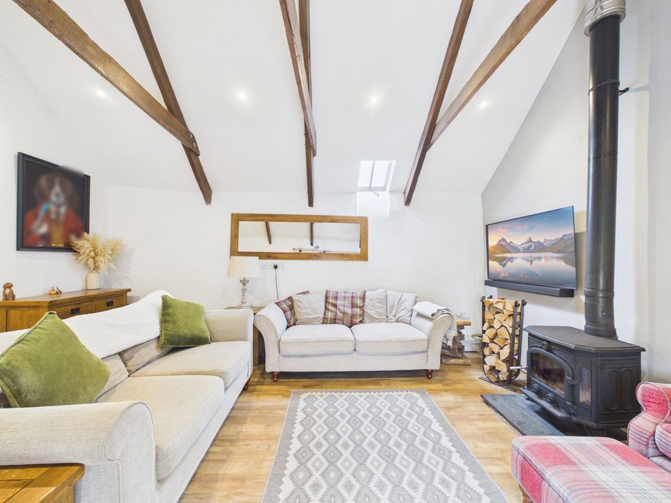 A living room with a sofa and television at Tor Farm in Advent near Camelford