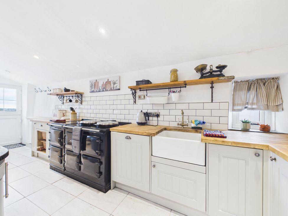 A kitchen with a sink and cooking range at Tor Farm in Advent near Camelford