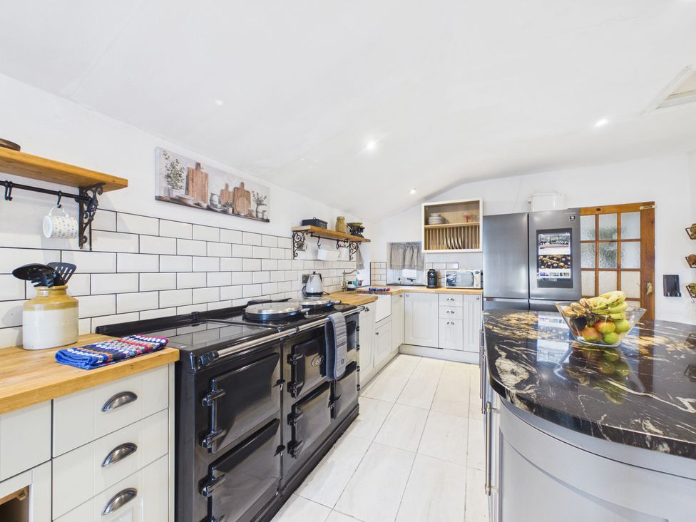A kitchen with an oven and refrigerator at Tor Farm Advent near Camelford
