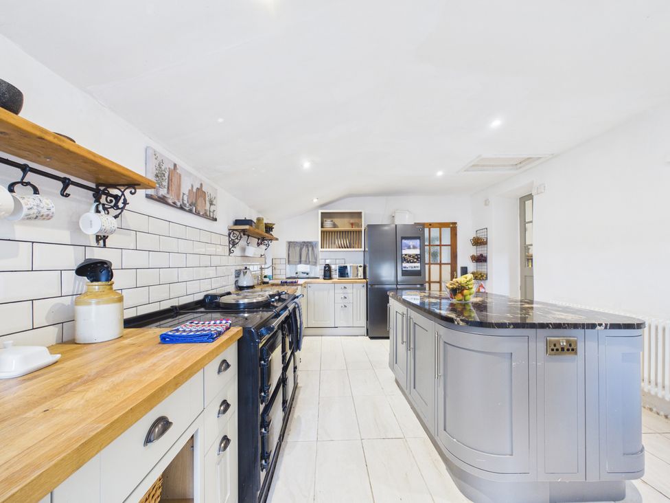 A kitchen with a cooking range and refrigerator at Tor Farm in Advent near Camelford