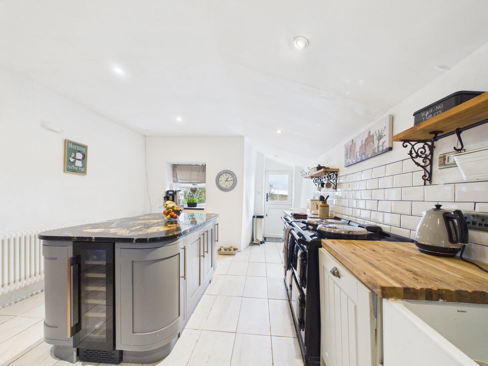 A kitchen with a large island and appliances at Tor Farm Advent near Camelford