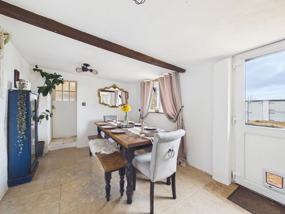 A dining room with a table and chairs at Tor Farm, Advent near Camelford
