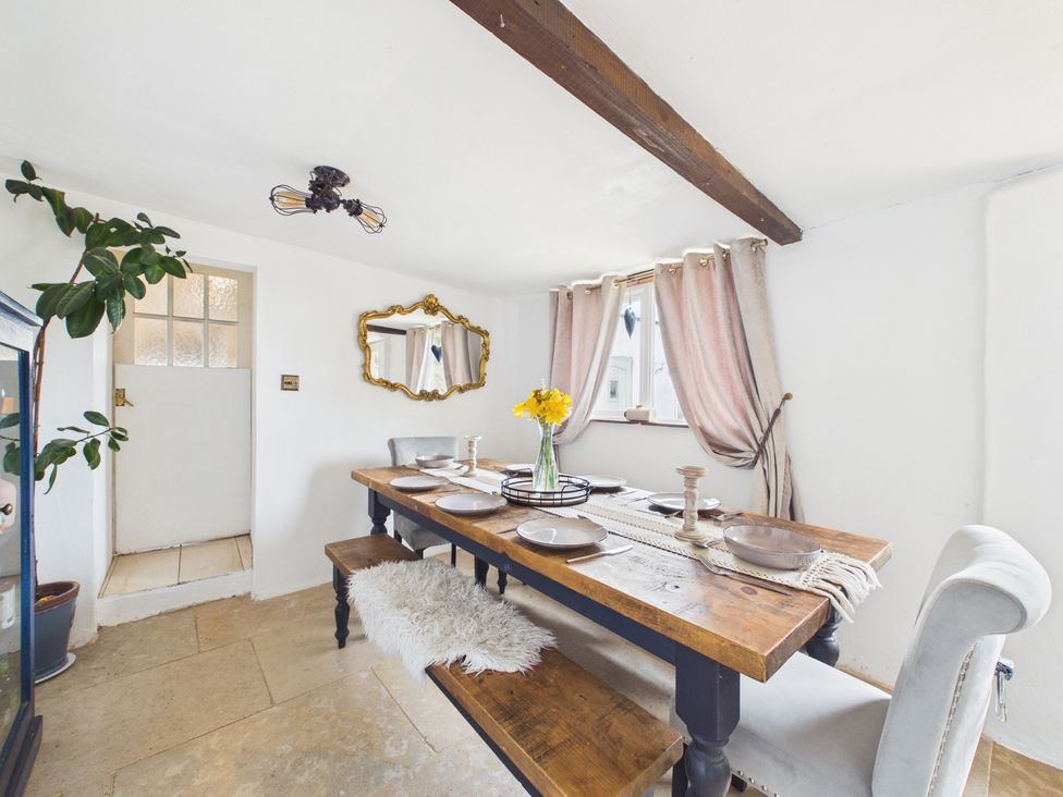 A dining room with a table set for meals at Tor Farm Advent near Camelford