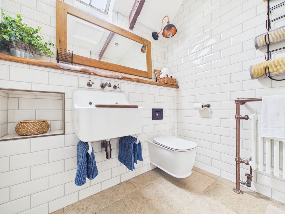 A bathroom with a sink, toilet and towels at Tor Farm in Advent near Camelford