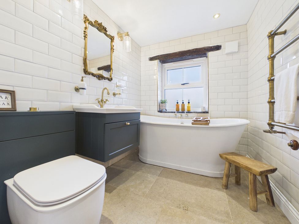 A bathroom with a bathtub, sink, and toilet at Tor Farm in Advent near Camelford