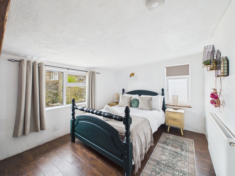 A bedroom with a bed and window at Tor Farm Advent near Camelford