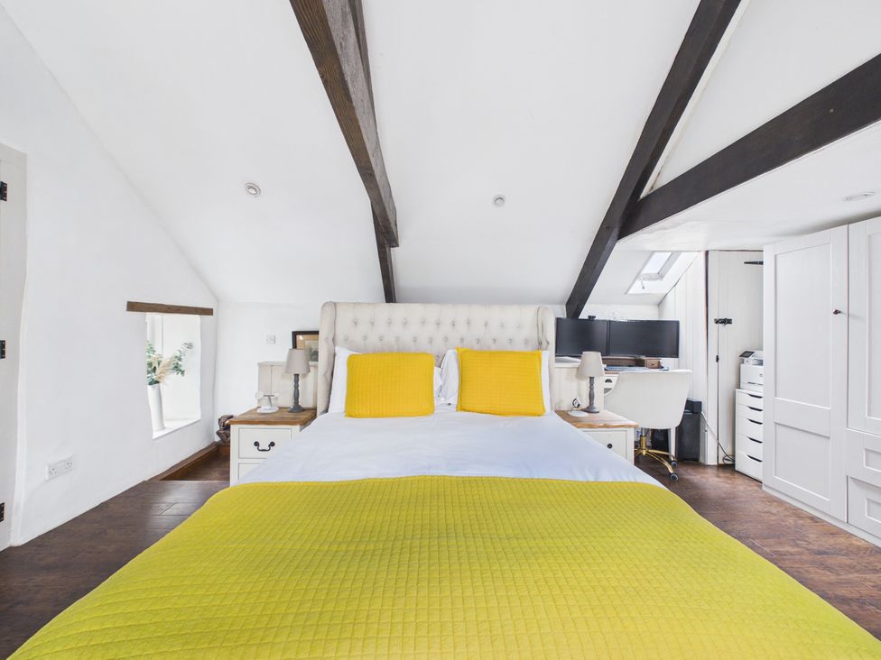 A bedroom with a bed and desk at Tor Farm Advent near Camelford