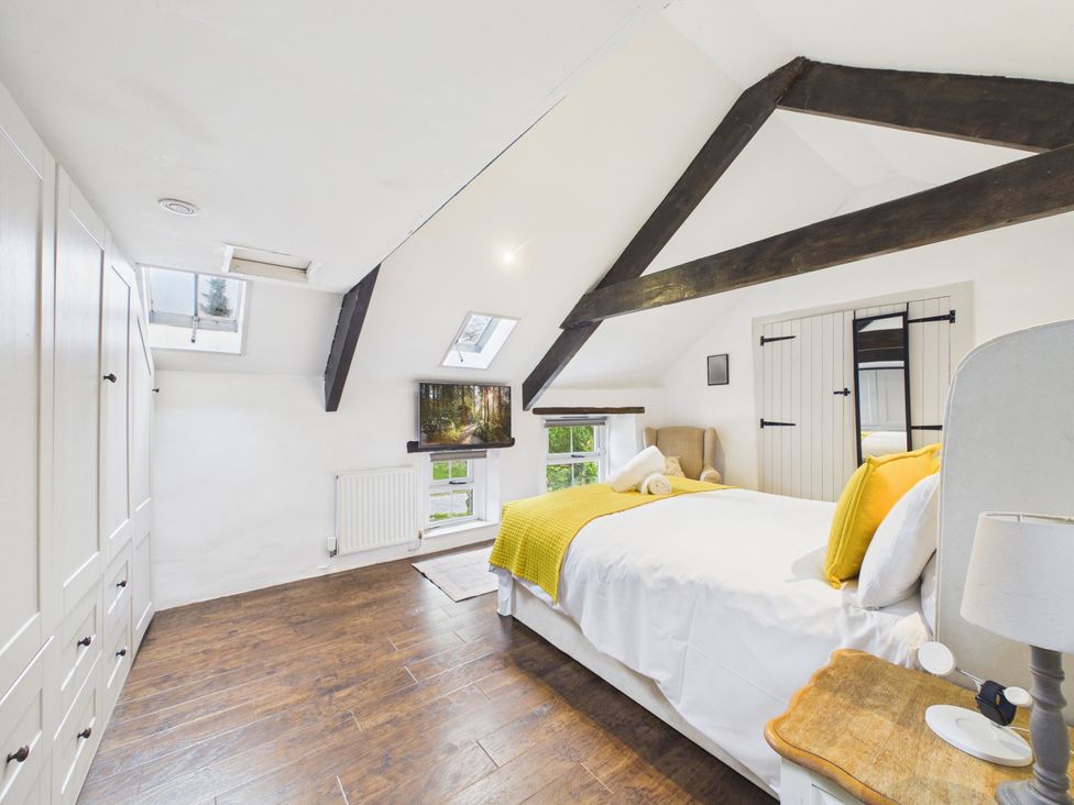 A bedroom with a bed and a television at Tor Farm in Advent near Camelford