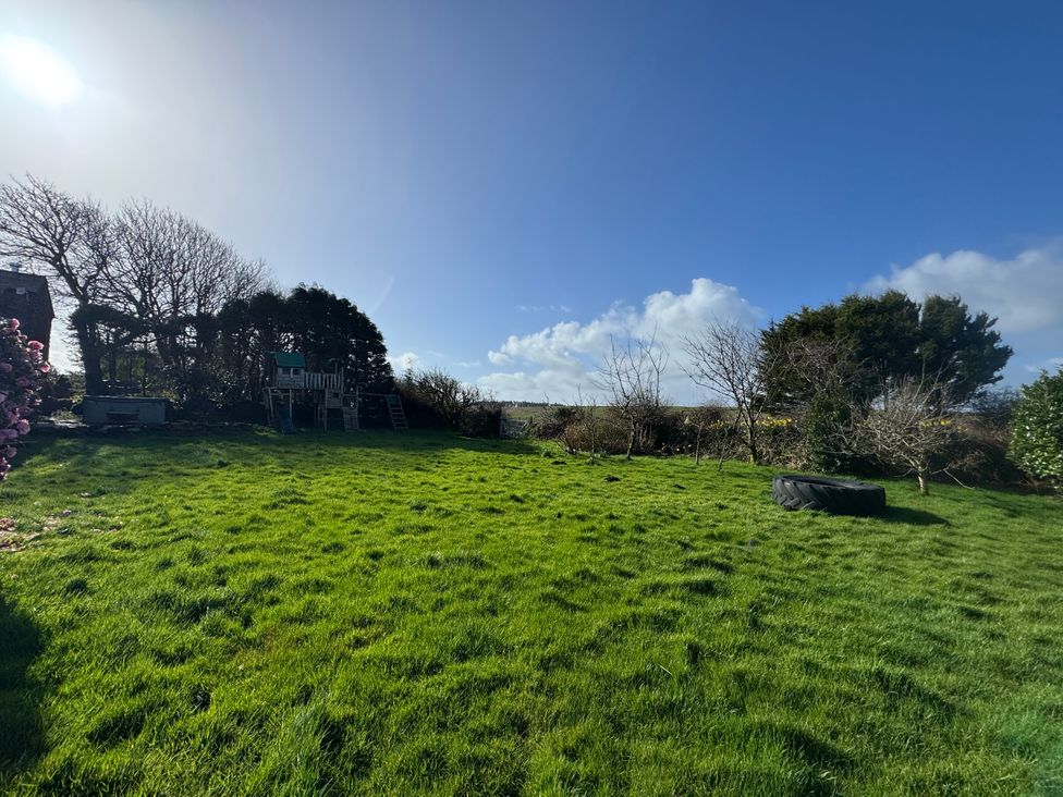 A garden with a play structure and tire at Tor Farm in Advent near Camelford