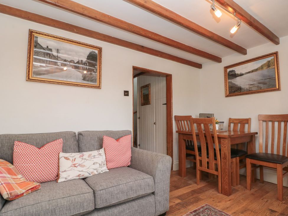 A dining room with a sofa and a dining table at Isla cottage