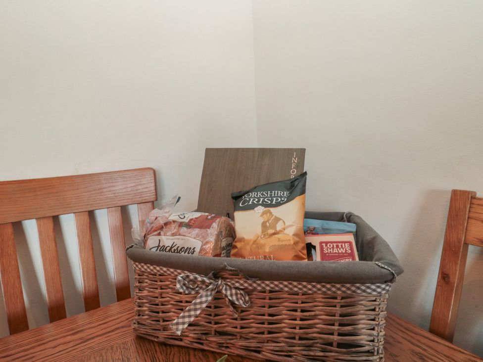 A basket with bread and snacks on a table at Isla cottage