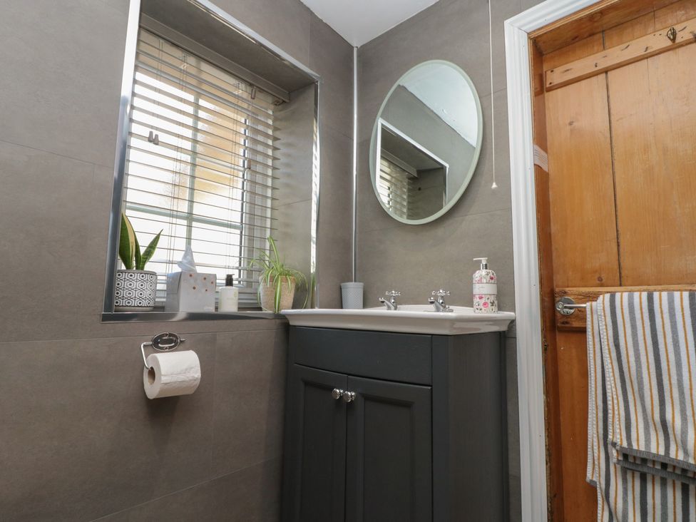 A bathroom with a sink and mirror at Isla cottage