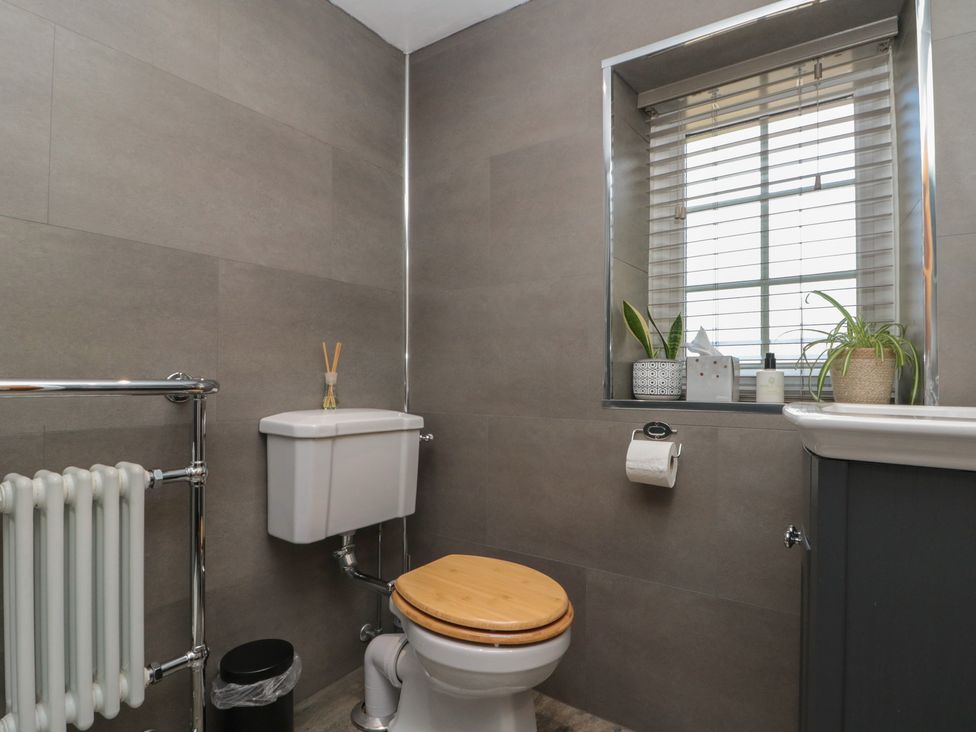 A bathroom with a toilet and a window at Isla cottage