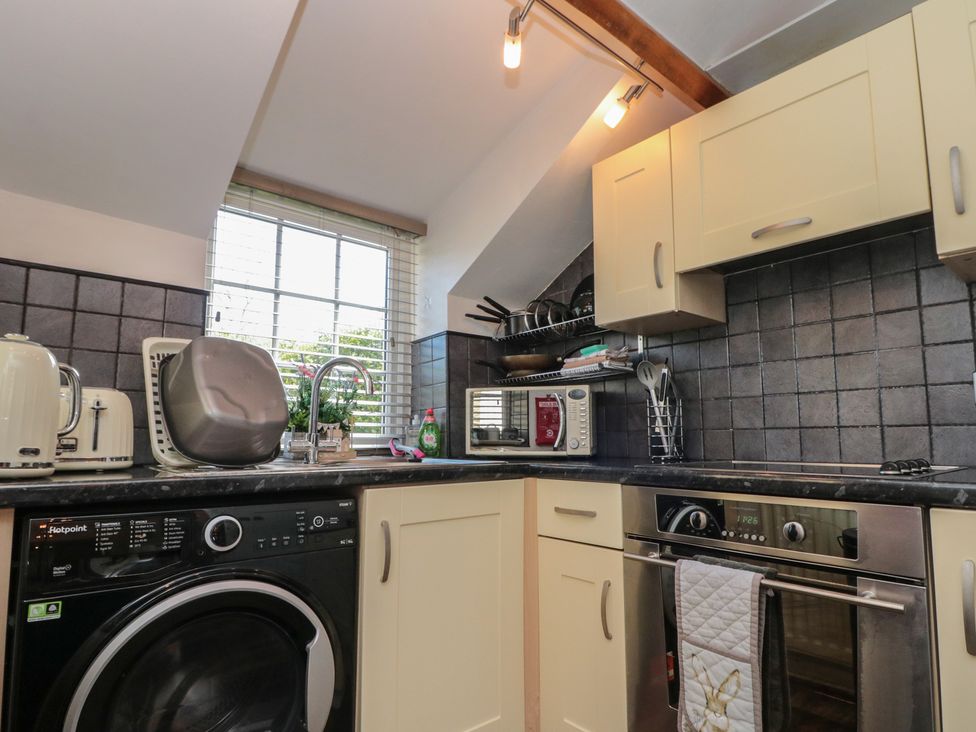 A kitchen with appliances and a window at Isla cottage