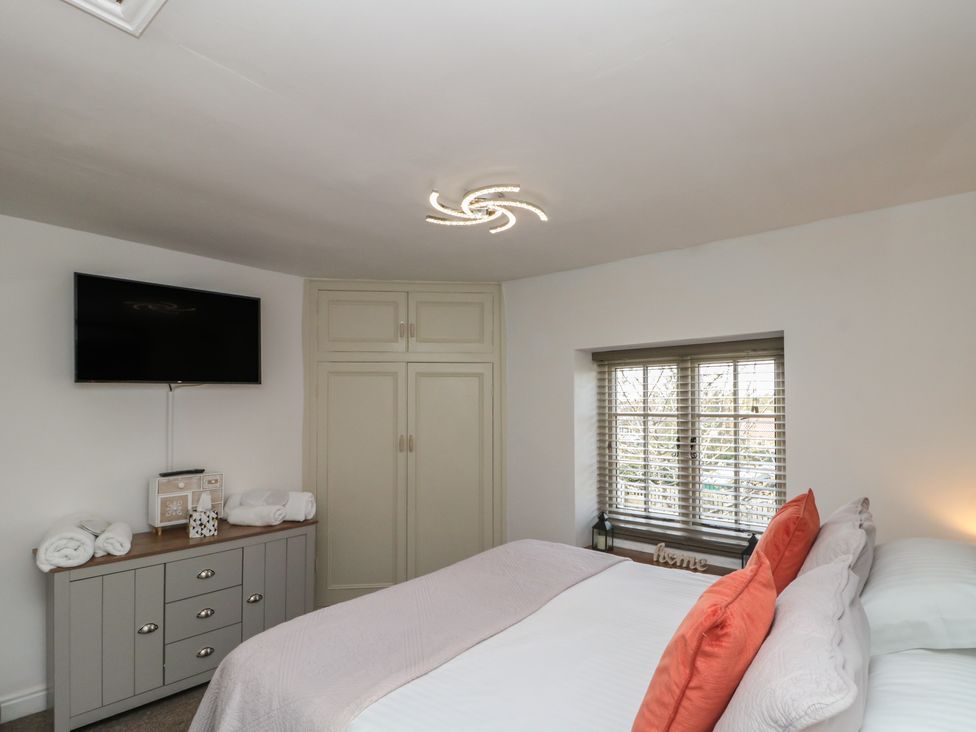 A bedroom with a bed and television at Isla cottage