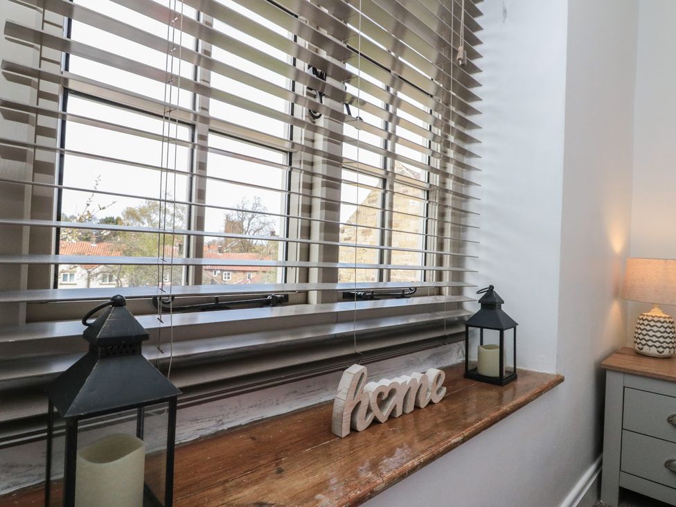 A window with blinds and decorative items at Isla cottage 