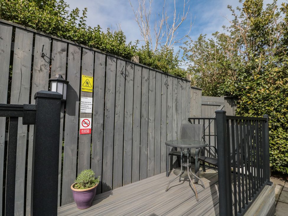 An outdoor space with a table and chair at Isla cottage 