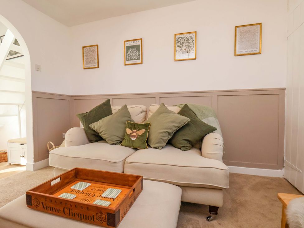 A living room with a sofa and picture frames at 1 Rosedale Abbey