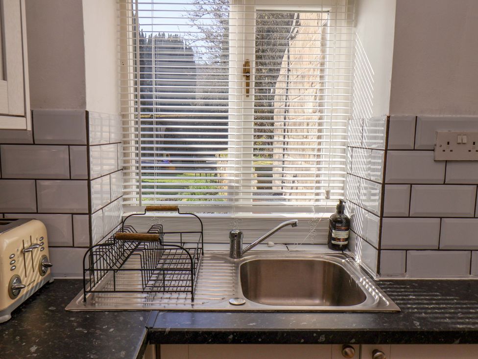 A kitchen with a sink and a dish rack at 1 Rosedale Abbey