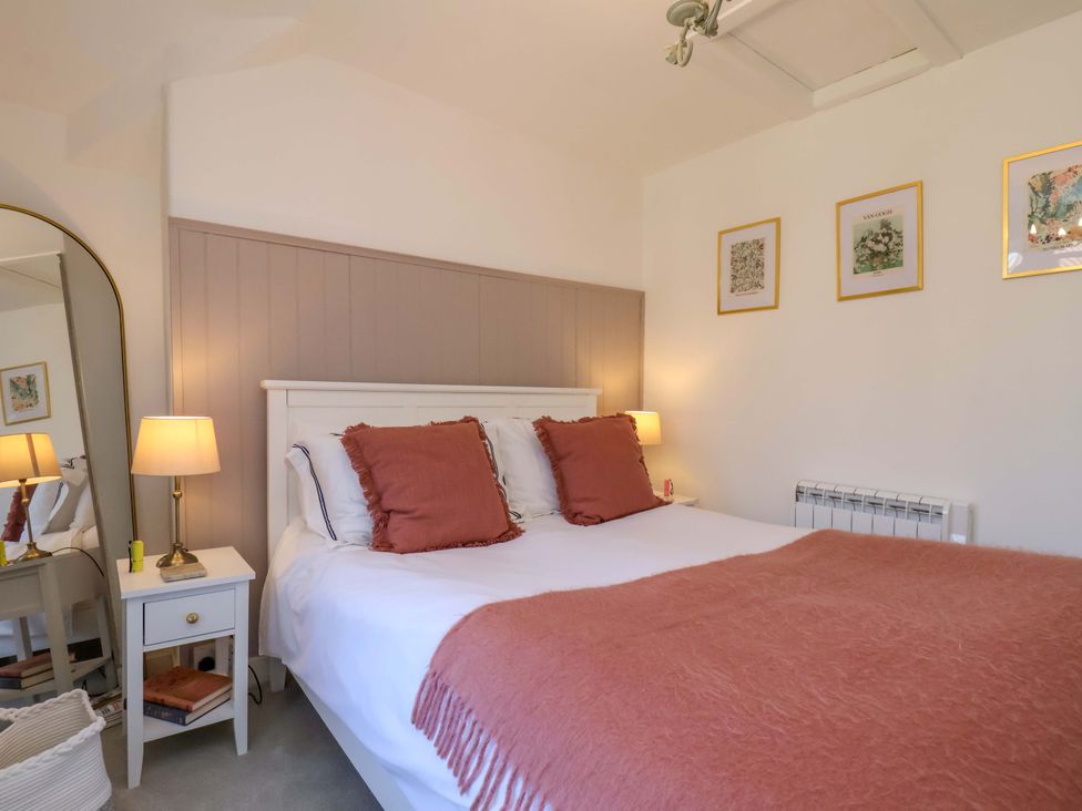 A bedroom with a bed and bedside table at 1 Rosedale Abbey
